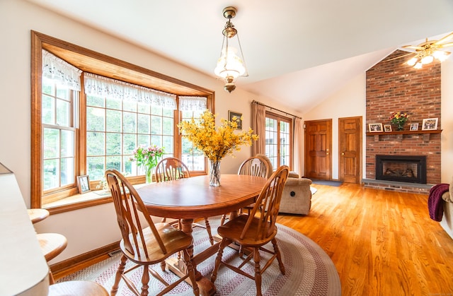 258 New Cheshire Rd, Wallingford, CT 06492 - dining space featuring light wood finished floors, a brick fireplace, and vaulted ceiling