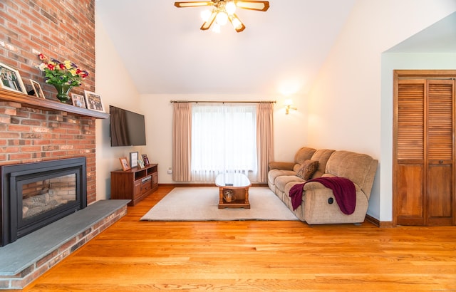 258 New Cheshire Rd, Wallingford, CT 06492 - living room with lofted ceiling, a ceiling fan, wood finished floors, and a fireplace