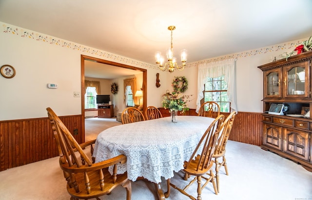 258 New Cheshire Rd, Wallingford, CT 06492 - dining area featuring light carpet, a wainscoted wall, a chandelier, plenty of natural light, and wood walls