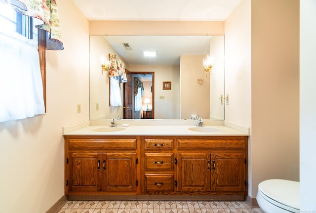 258 New Cheshire Rd, Wallingford, CT 06492 - bathroom featuring double vanity and toilet