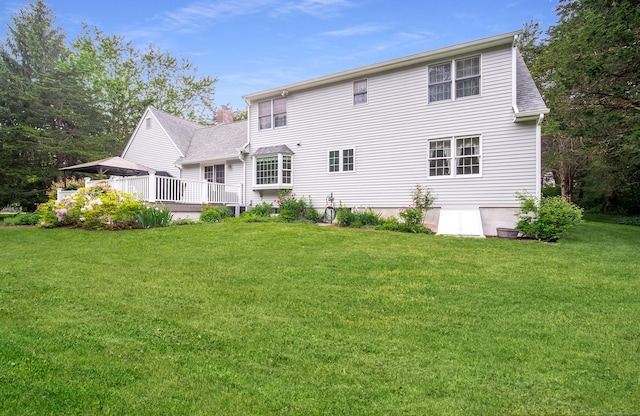 258 New Cheshire Rd, Wallingford, CT 06492 - rear view of property featuring a lawn and a deck