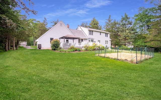 258 New Cheshire Rd, Wallingford, CT 06492 - back of property featuring a chimney, a yard, a garden, and a gazebo