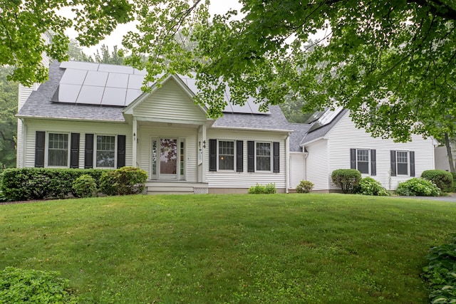 44 Richard Ave, Wolcott, CT 06716 - view of front facade featuring solar panels, a front yard, and roof with shingles