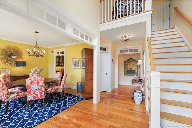 8 Meadowview Dr, Brookfield, CT 06804 - dining space with a chandelier, stairway, wood finished floors, and crown molding