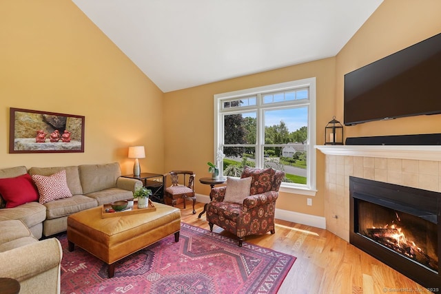 8 Meadowview Dr, Brookfield, CT 06804 - living area with vaulted ceiling, a tiled fireplace, and wood finished floors