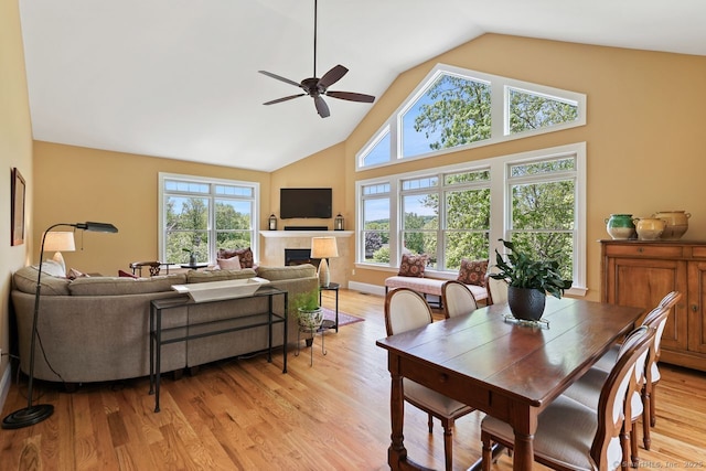 8 Meadowview Dr, Brookfield, CT 06804 - dining room with a ceiling fan, light wood-type flooring, a tile fireplace, and high vaulted ceiling