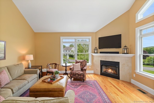 8 Meadowview Dr, Brookfield, CT 06804 - living area featuring wood finished floors, plenty of natural light, a tiled fireplace, and high vaulted ceiling