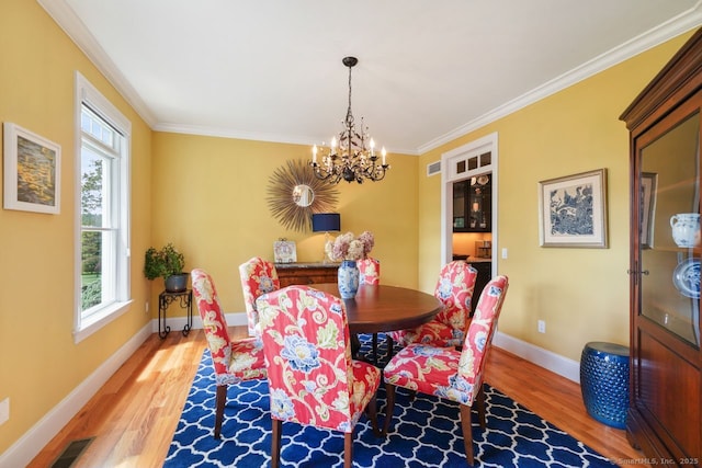 8 Meadowview Dr, Brookfield, CT 06804 - dining space with light wood-style flooring, a chandelier, and crown molding