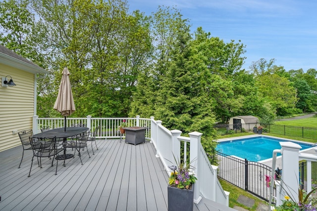 8 Meadowview Dr, Brookfield, CT 06804 - wooden deck featuring outdoor dining area, view of wooded area, and a shed