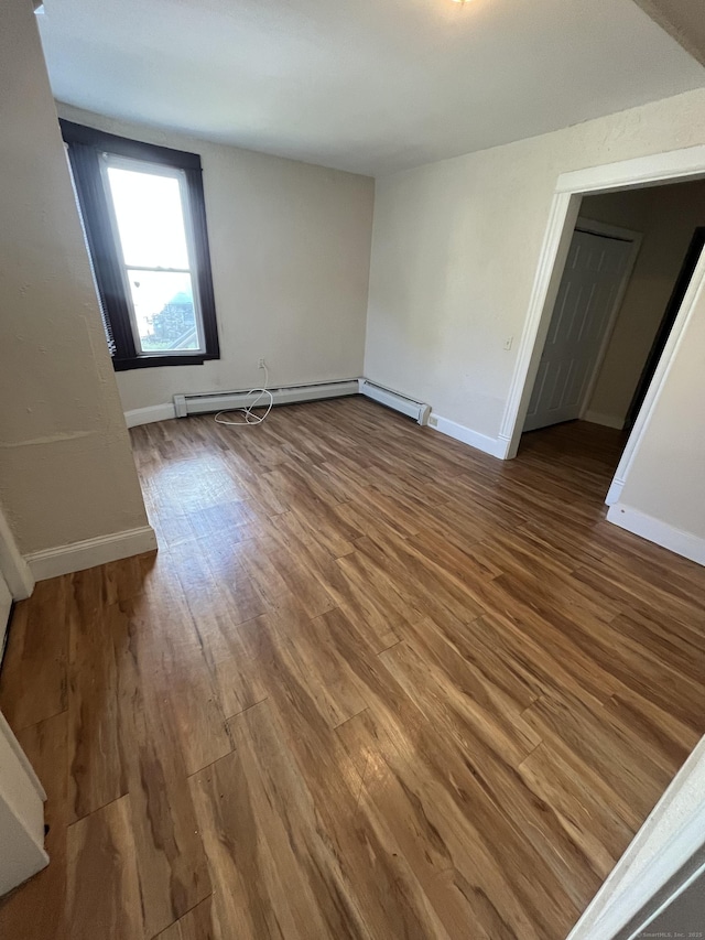 54 Morningside Ave, Waterbury, CT 06708 - empty room with wood finished floors, baseboards, and a baseboard radiator