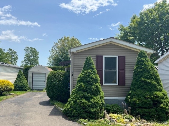 24 Ella Cir, Milford, CT 06460 - view of side of home featuring asphalt driveway