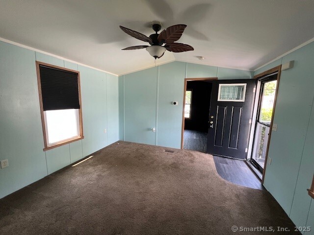 24 Ella Cir, Milford, CT 06460 - carpeted spare room featuring lofted ceiling and ceiling fan