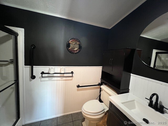 24 Ella Cir, Milford, CT 06460 - bathroom with a shower stall, vanity, toilet, and tile patterned flooring