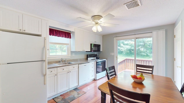 55 Addison Pond Rd Unit 55, Glastonbury, CT 06033 - kitchen featuring white appliances, white cabinetry, a textured ceiling, light wood-style floors, and a ceiling fan