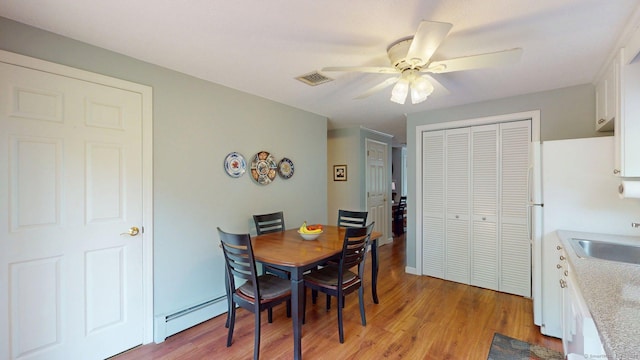 55 Addison Pond Rd Unit 55, Glastonbury, CT 06033 - dining space with a baseboard radiator, a ceiling fan, and light wood-type flooring