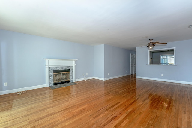 2 Mansfield Grove Rd Apt 374, East Haven, CT 06512 - unfurnished living room with wood finished floors, a fireplace with flush hearth, a ceiling fan, and baseboards