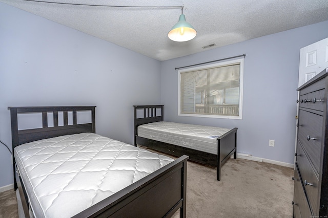 2 Mansfield Grove Rd Apt 374, East Haven, CT 06512 - bedroom featuring light colored carpet, baseboards, and a textured ceiling