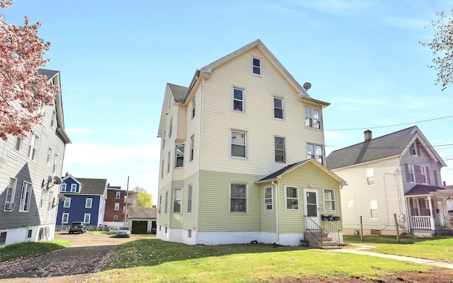 127 Smalley St, New Britain, CT 06051 - rear view of house featuring entry steps and a yard