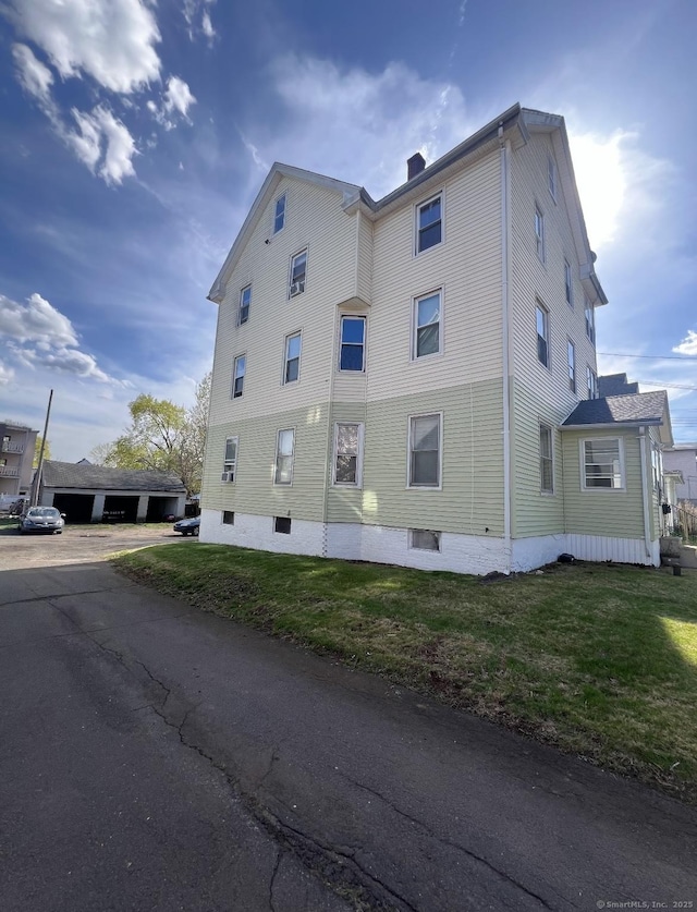 127 Smalley St, New Britain, CT 06051 - view of home's exterior featuring a chimney and a lawn