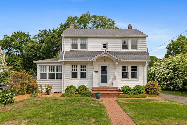 10 Fernwood St, Wethersfield, CT 06109 - view of front of house featuring a chimney, entry steps, roof with shingles, and a front yard