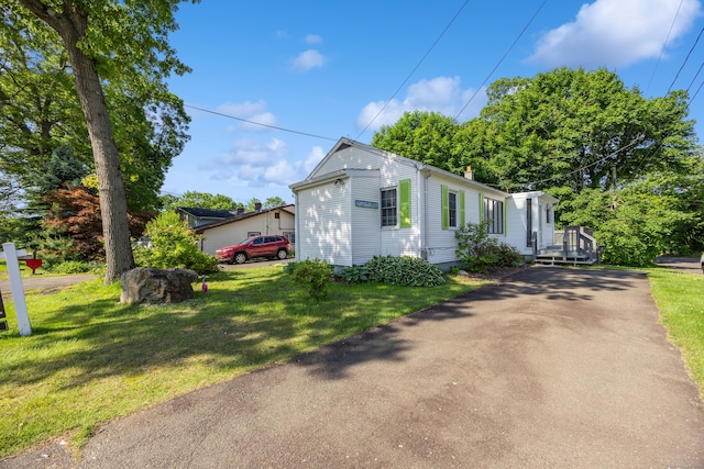 134 Mansfield Grove Rd, East Haven, CT 06512 - view of front of house with a chimney and a front lawn