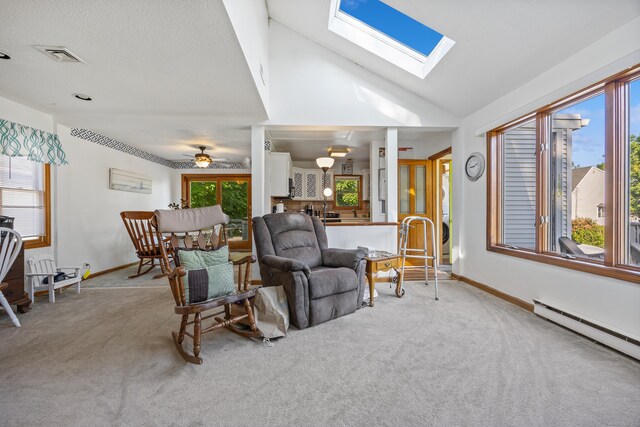 134 Mansfield Grove Rd, East Haven, CT 06512 - carpeted living room featuring a baseboard radiator, a skylight, vaulted ceiling, and baseboards