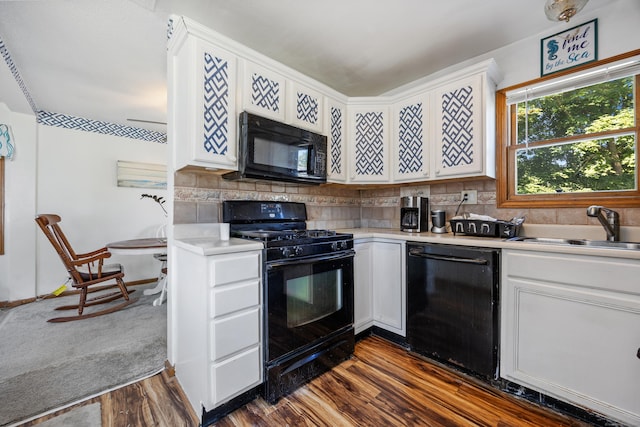 134 Mansfield Grove Rd, East Haven, CT 06512 - kitchen with black appliances, light countertops, white cabinetry, decorative backsplash, and dark wood-style floors