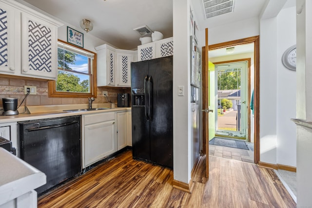 134 Mansfield Grove Rd, East Haven, CT 06512 - kitchen with black appliances, a sink, dark wood-type flooring, and white cabinets