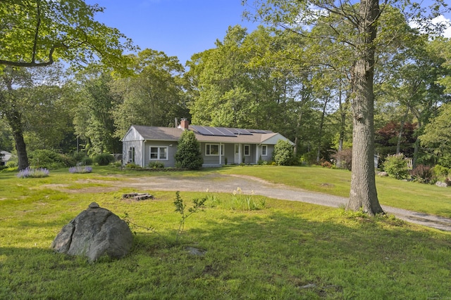 64 Obed Hts, Old Saybrook, CT 06475 - ranch-style house with roof mounted solar panels, a front yard, and a chimney