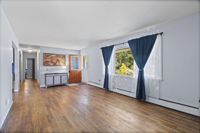 64 Obed Hts, Old Saybrook, CT 06475 - unfurnished living room with wood finished floors, a baseboard heating unit, and baseboards