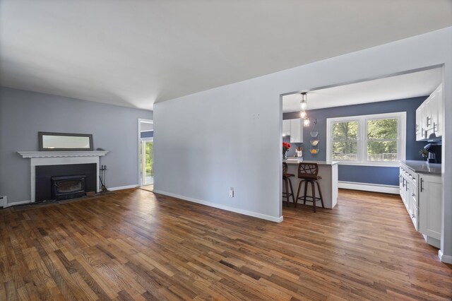64 Obed Hts, Old Saybrook, CT 06475 - unfurnished living room with dark wood-style flooring, a baseboard heating unit, and baseboards