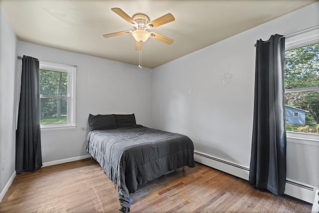 64 Obed Hts, Old Saybrook, CT 06475 - bedroom with baseboard heating, multiple windows, and light wood-type flooring
