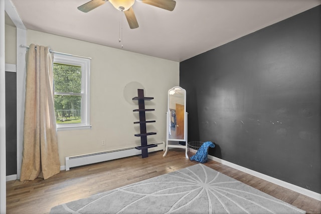 64 Obed Hts, Old Saybrook, CT 06475 - exercise room featuring a baseboard heating unit, wood finished floors, ceiling fan, and baseboards