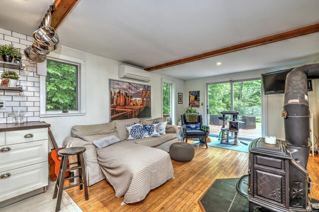 225 Rocky Mountain Rd, Southbury, CT 06488 - living area featuring a wall mounted air conditioner, beam ceiling, and light wood-type flooring