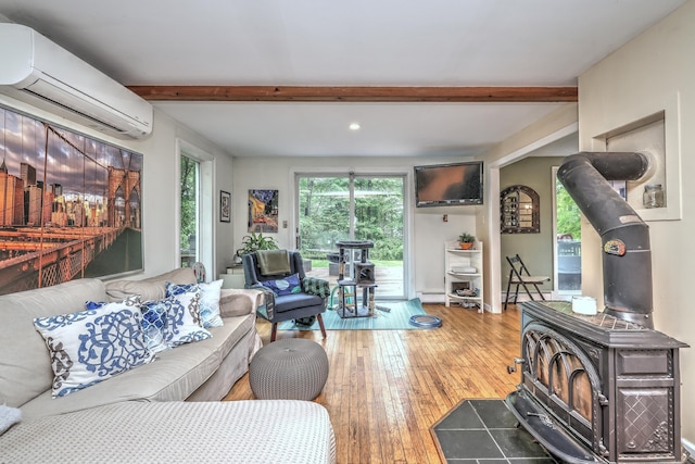 225 Rocky Mountain Rd, Southbury, CT 06488 - living area featuring a wood stove, a wall mounted air conditioner, beam ceiling, wood-type flooring, and recessed lighting