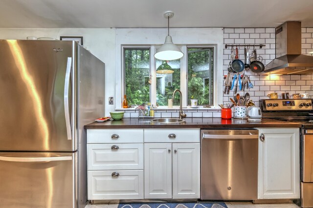 225 Rocky Mountain Rd, Southbury, CT 06488 - kitchen with appliances with stainless steel finishes, wall chimney exhaust hood, a sink, dark countertops, and white cabinetry