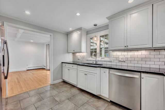 206 Ludlow Rd, Manchester, CT 06040 - kitchen featuring appliances with stainless steel finishes, a baseboard radiator, dark countertops, crown molding, and backsplash