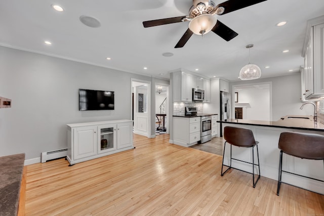 206 Ludlow Rd, Manchester, CT 06040 - kitchen featuring stainless steel appliances, baseboard heating, decorative backsplash, dark countertops, and recessed lighting