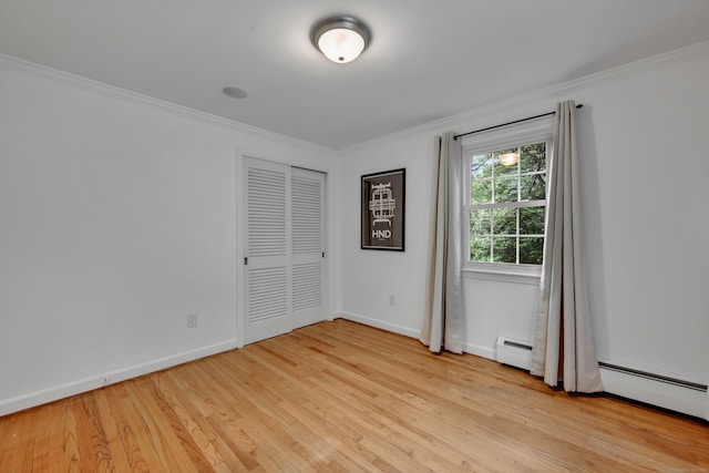 206 Ludlow Rd, Manchester, CT 06040 - unfurnished bedroom with light wood finished floors, ornamental molding, a baseboard heating unit, and a closet