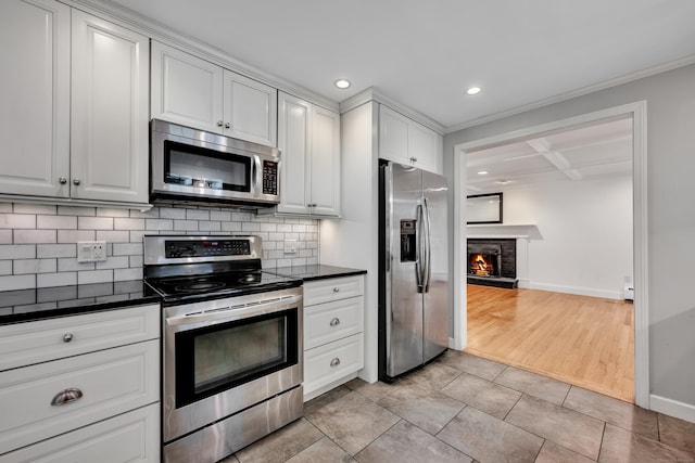 206 Ludlow Rd, Manchester, CT 06040 - kitchen featuring stainless steel appliances, dark countertops, tasteful backsplash, recessed lighting, and ornamental molding