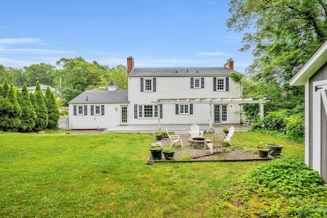 206 Ludlow Rd, Manchester, CT 06040 - rear view of house with a pergola, a patio, an outdoor fire pit, a chimney, and a yard