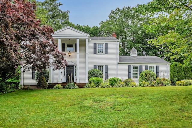 206 Ludlow Rd, Manchester, CT 06040 - greek revival house featuring a chimney, a front lawn, and a shingled roof