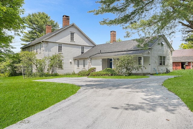 27 Tobey Hill Rd, North Canaan, CT 06018 - view of front of house with a chimney, a front yard, and driveway