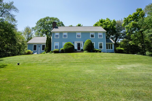 12 Northwoods Rd, Granby, CT 06060 - colonial house featuring a chimney and a front yard