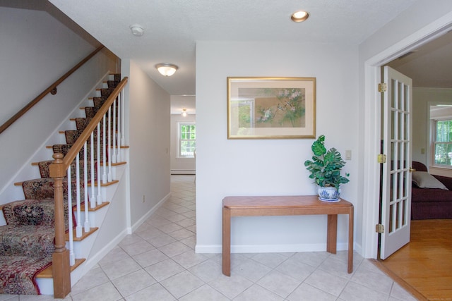12 Northwoods Rd, Granby, CT 06060 - hallway featuring stairway, plenty of natural light, and light tile patterned floors