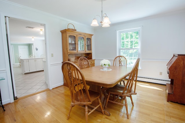 12 Northwoods Rd, Granby, CT 06060 - dining area featuring baseboard heating, light wood finished floors, a chandelier, and ornamental molding