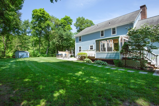 12 Northwoods Rd, Granby, CT 06060 - rear view of property with a patio, a sunroom, and a lawn