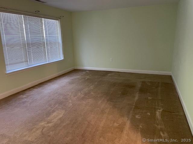 150 Forest Rd Unit 40, Milford, CT 06461 - carpeted empty room with baseboards