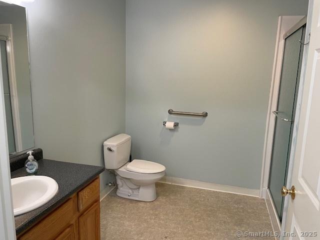 150 Forest Rd Unit 40, Milford, CT 06461 - full bathroom with vanity, an enclosed shower, baseboards, and toilet
