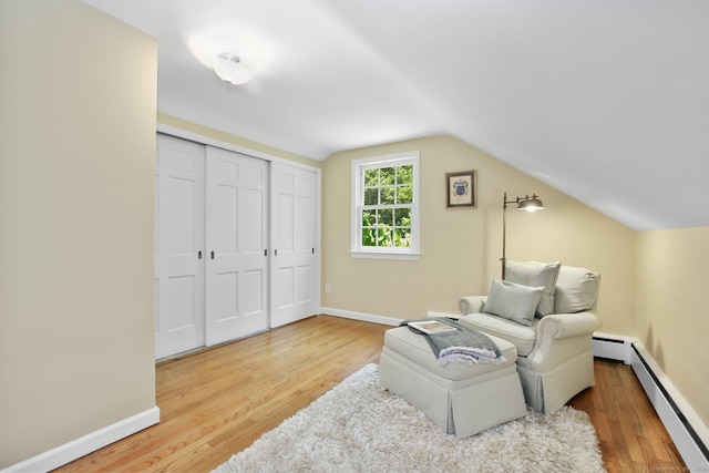 151 Woodridge Dr, New Canaan, CT 06840 - living area with baseboard heating, wood finished floors, lofted ceiling, and baseboards